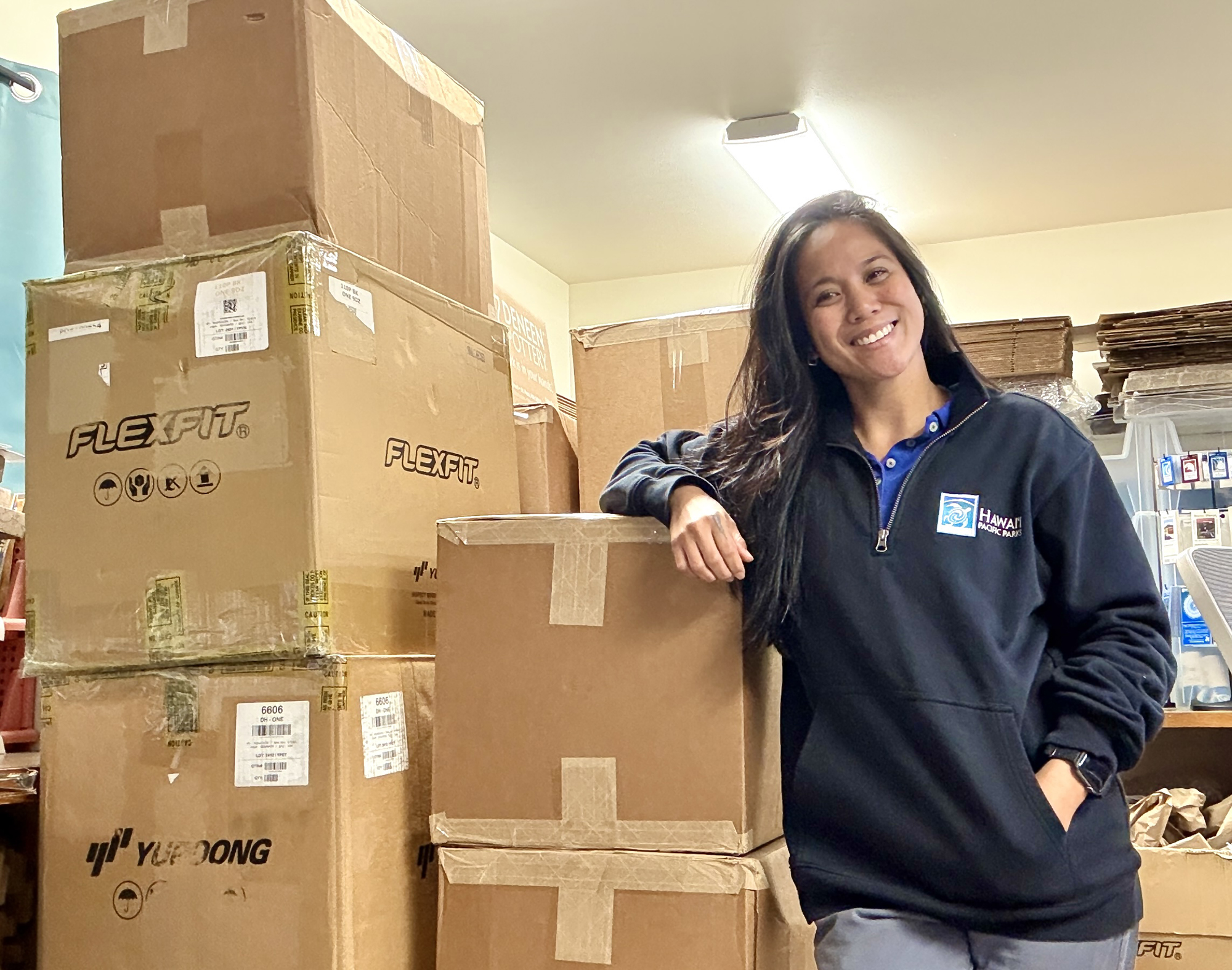Kiry Galipir stands with a large order of Hawaiian native species plush destined for preschools.
