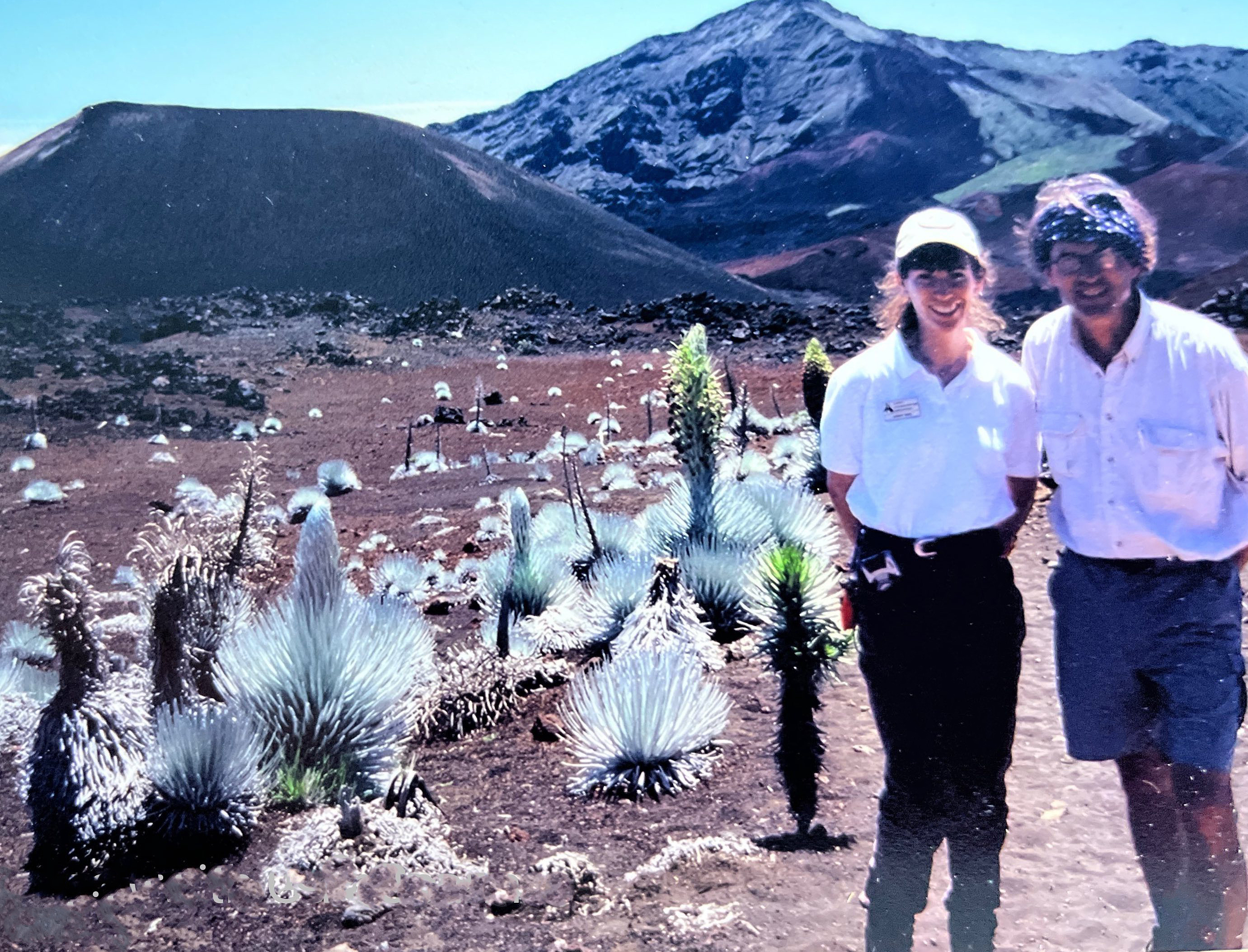 Wendy Hatch stands with a park ranger near silversword plants at Haleakala National Park